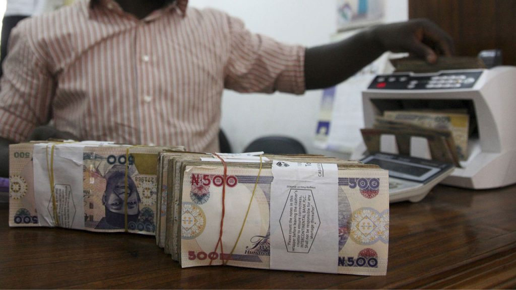 Man counting money for online businesses and FG's ₦50bn Credit Facility (TCF)