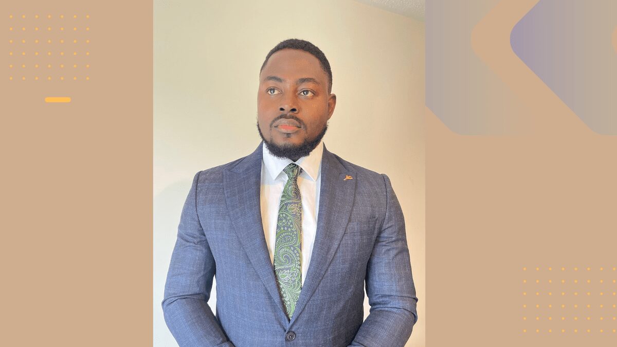 Confident professional man in a tailored suit and patterned tie, standing in a modern office space, representing SMEPEAKS business growth, leadership, and corporate success.