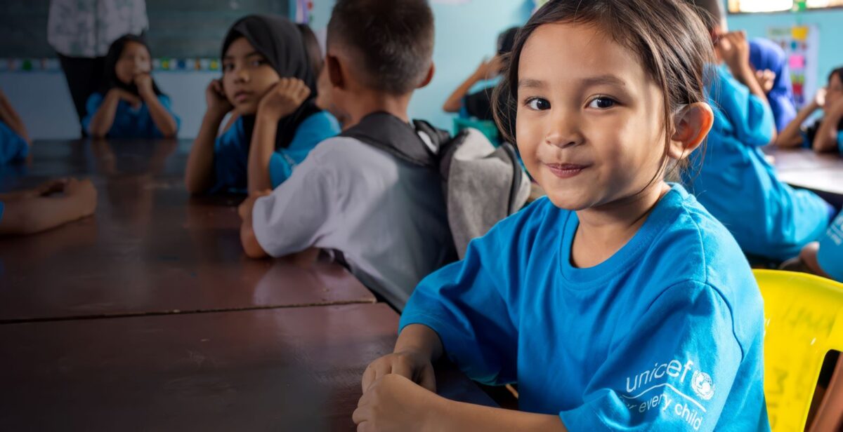 A girl child wearing branded UNICEF T-shirts depicting UNICEF Venture Fund opportunity for chldren-focused innovators