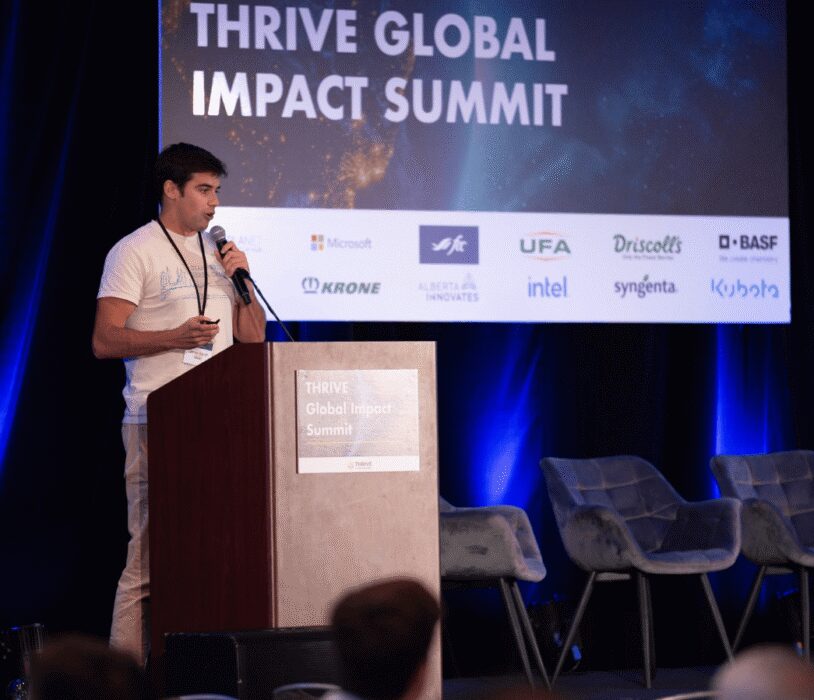 Innovative speaker presenting at the Thrive Global Impact Summit, focusing on business growth and technology solutions.